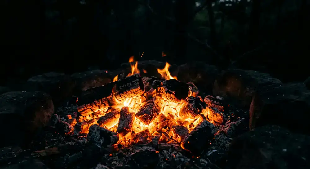 Glowing coals and embers in the dark